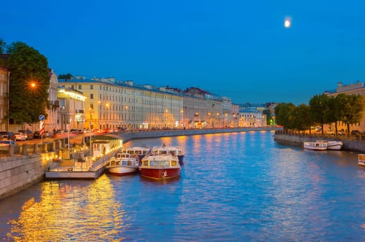 Boats waiting for tourists to take famous tourist attraction - boat trip by the canals. Saint Petersburg, Russia