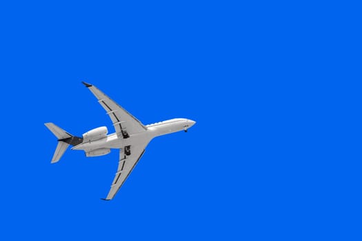 White Plane with Landing Gear in the Sky