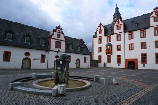 The forecourt of Hadamar Castle with a fountain in front of the Glass Museum...