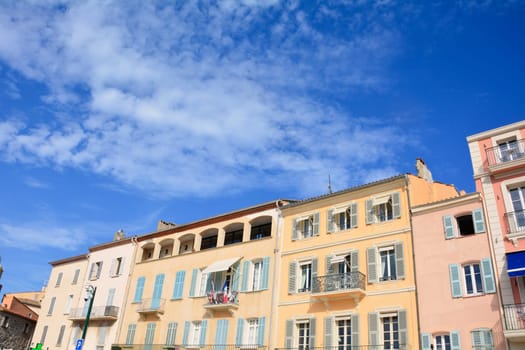 House facade in the historic center of Saint Tropez, France, with balconies and many blue sky and copy space