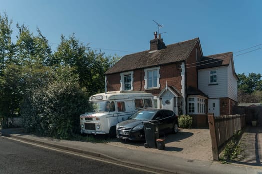 A vintage ambulance parked on the front garden of a cottage in the village of Staplehurst, Kent, UK
