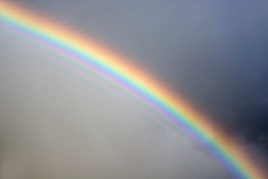 rainbow against a stormy grey sky
