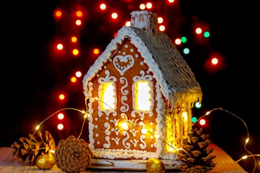 Gingerbread house with bokeh of light bulbs in the background