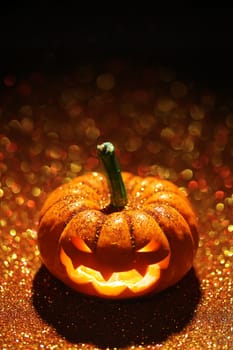 Glowing Jack-o-Lantern on sparkly orange background