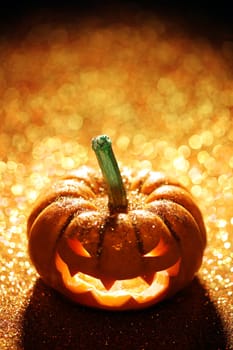 Glowing Jack-o-Lantern on sparkly orange background