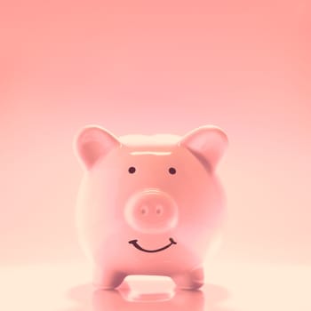 Smiling Piggybank on pink background. Saving money concept.