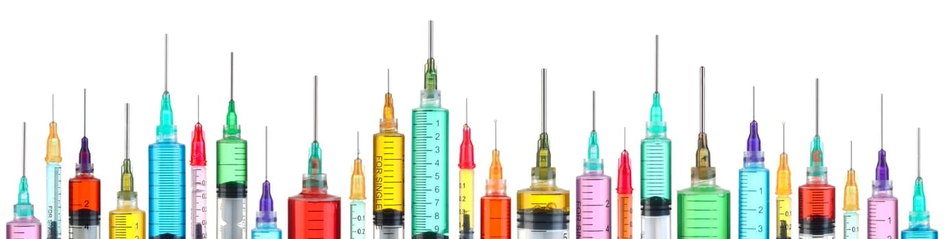 Row of bright colorful syringes