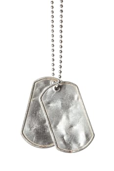 Old and worn blank military dog tags with chain isolated on white