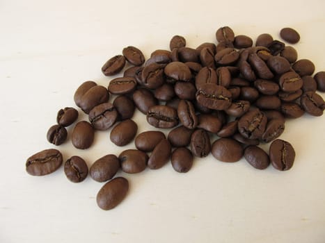 Roasted organic Arabian coffee beans on a wooden board