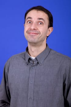 an young man portrait over a blue background