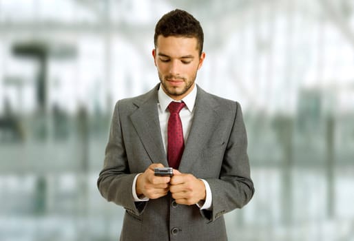 young business man looking to his phone