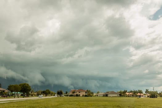 Dark stormy clouds carrying heavy rainfall on a typical summer day in Cape Coral Florida