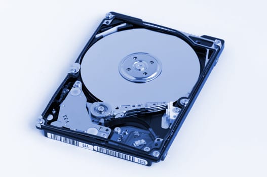 Opened hard disk showing the disk surface and drive head