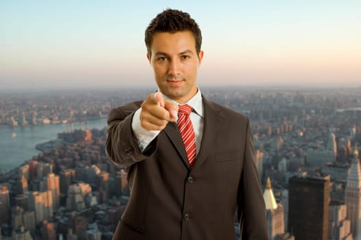 young business man in a suit pointing with his finger
