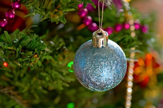 Some christmas balls decorated on a tree
