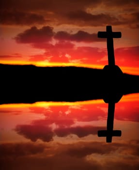 cross silhouette and the clouds at sunset