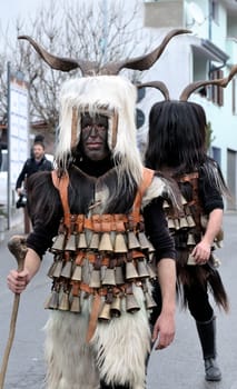 Orani, Sardinia, Italy - February 15, 2015: Parade of traditional masks of Sardinia during the Carnival 2015 in Orani.