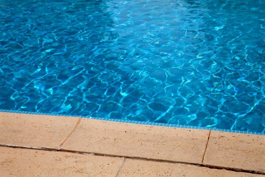 swimming pool blue water detail in summer time