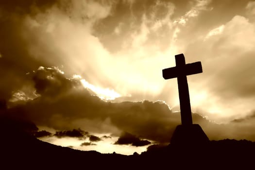 cross detail in silhouette and the clouds in the sky