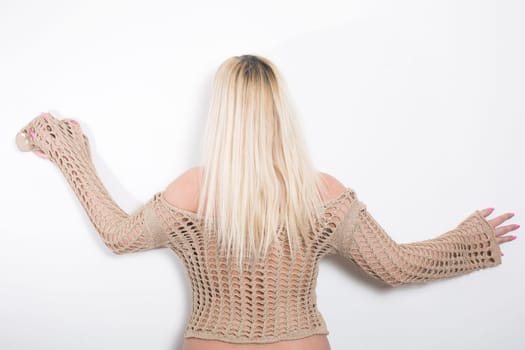 Woman in dress shot from the back in studio on white