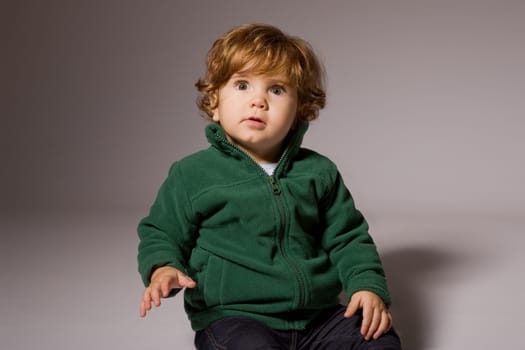 young baby portrait on a grey background