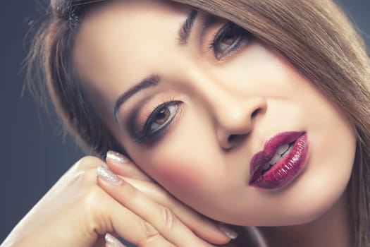 Beautiful young Thai woman with makeup and nails done