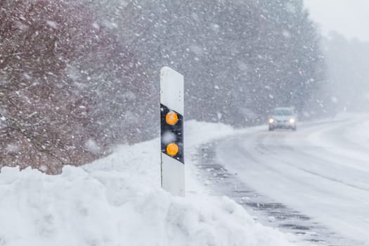 The street track is slick and frozen. High dangerous risk of an accident through the blizzard snowstorm and severe weather at christmas time season.