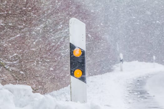 The street track is slick and frozen. High dangerous risk of an accident through the blizzard snowstorm and severe weather at christmas time season.