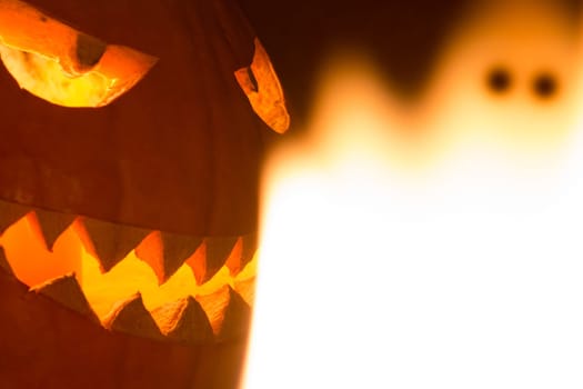 Big helloween autumn symbol with mad face, glowing eyes, mouth and teeth. Scary hot nightmare horror with evil smile at october 31st.