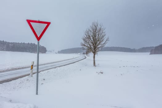 The street track is slick and frozen. High dangerous risk of an accident through the blizzard snowstorm and severe weather at christmas time season.