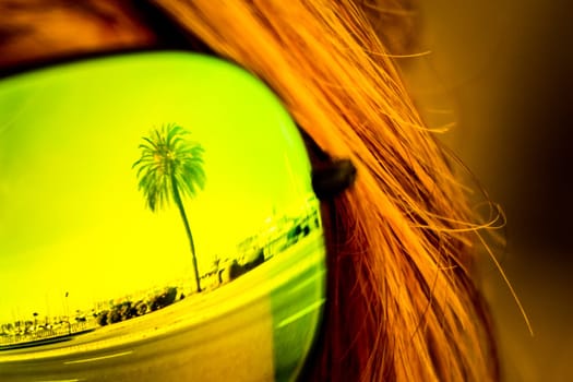 Exciting mirror imaging at sunglasses on head. Beautiful symbol of tourism vacation trip travelling to holiday dream island. Copypace.