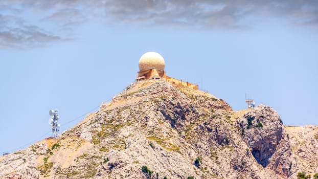 Puig Major observatory on top of a mountain with cloudy blue sky in background, Mallorca island, Spain
