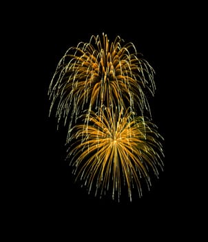 Beautiful Golden fireworks exploding in the night sky, isolated on black background. New year and anniversary concept.