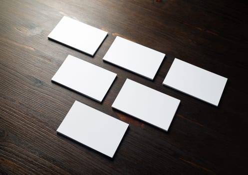 Photo of blank business cards on a wooden background. Template for ID.