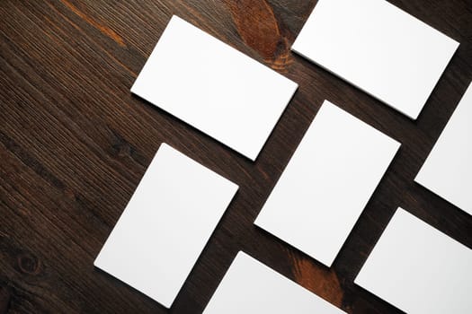 Blank white business cards mock-up on wooden background.Copy space for text. Flat lay.