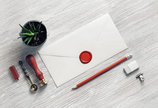 Blank retro stationery and envelope on light wood table background. Flat lay.