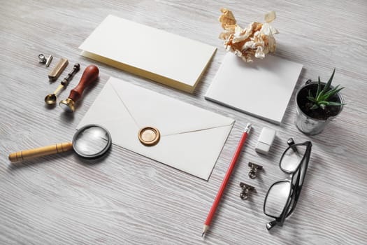 Vintage stationery set on light wood table background. Branding mock-up.