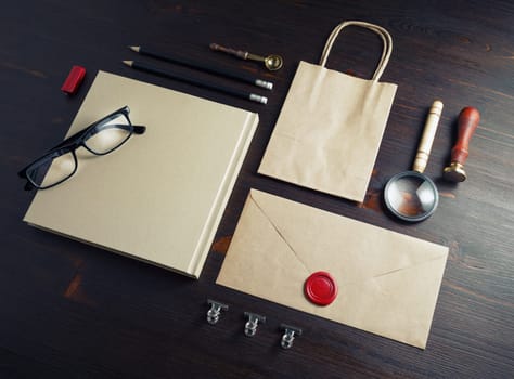 Blank branding identity set on wooden background. Kraft paper stationery template.
