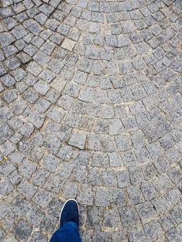 Picture taken up to down of foot on a paved floor