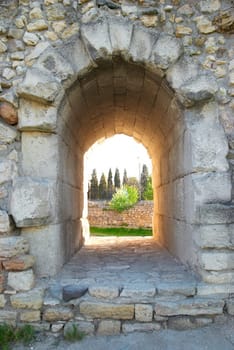 Exit in the ancient wall. Entrance to the green park