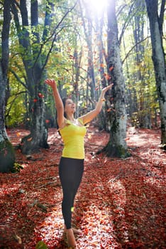 Pretty girl in the autumn forest with yellow leaves