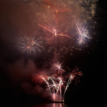 Colorful holiday fireworks on the black sky background.