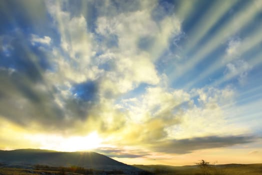 Sunset blue sky with sun and clouds