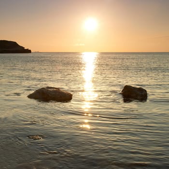 Sea shore and stones. Seascape at sunset.