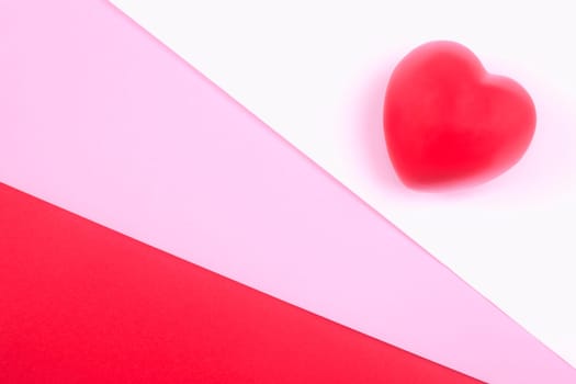 Red heart on white, pink and red background, symbol of love for Valentines day, minimalism.