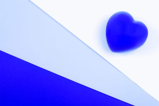Blue heart on white and blue background, symbol of love for Valentines day, minimalism.