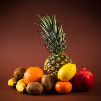 Some exotic or tropical fruits are on brown background.