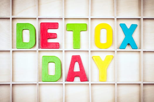DETOX DAY text from colorful wooden letters on board, detox and diet concept.