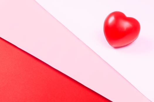 Abstract red heart on white, pink and red background, symbol of love, minimalism.