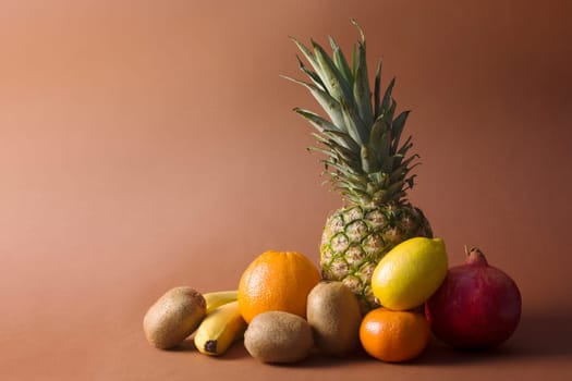 Different exotic tropical fruits are on brown background.